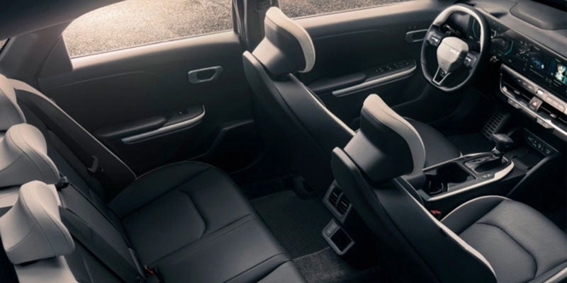 Car interior showing front and rear seats with a modern dashboard.